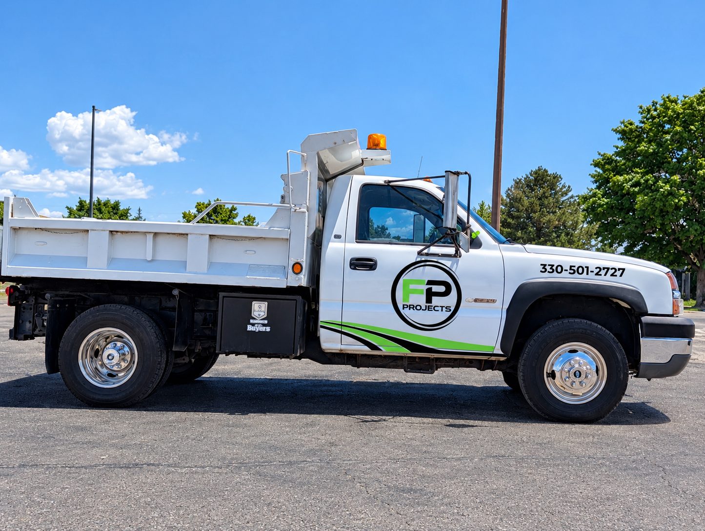 FP Projects LLC dump truck with company logo and phone number